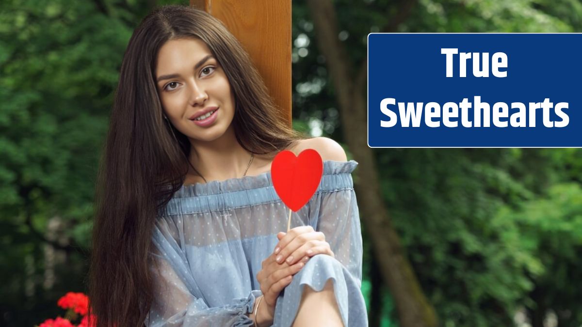 Pretty cheerful brunette woman holding a red heart.