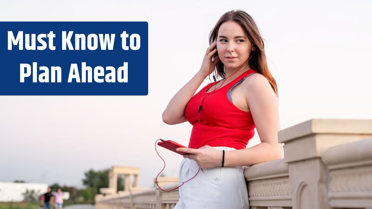 Teenager girl standing in the park listening to the music and chatting on her phone at sunset.