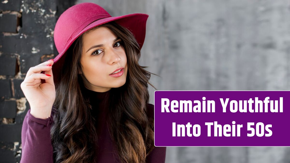 Beautiful young woman with hat on her head looking at camera.