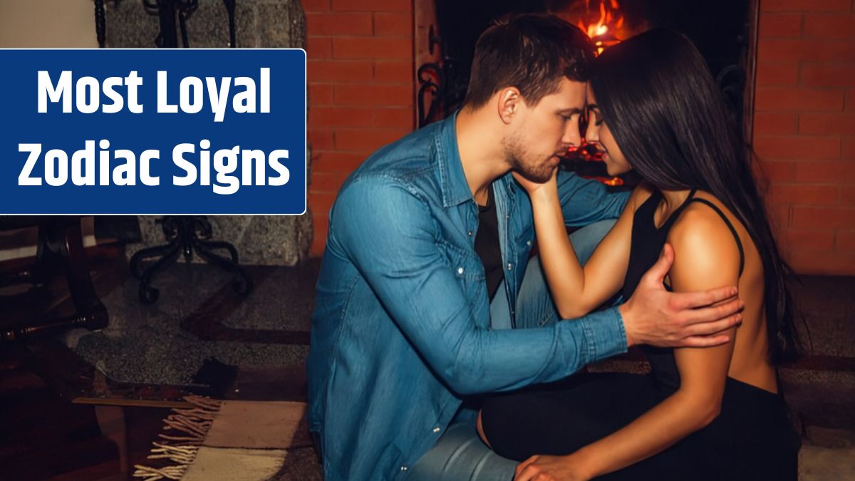 Tender and romantic picture of young couple sitting together at fireplace. They touch their foreheads and look in eyes. Guy hold hand on her forearm.