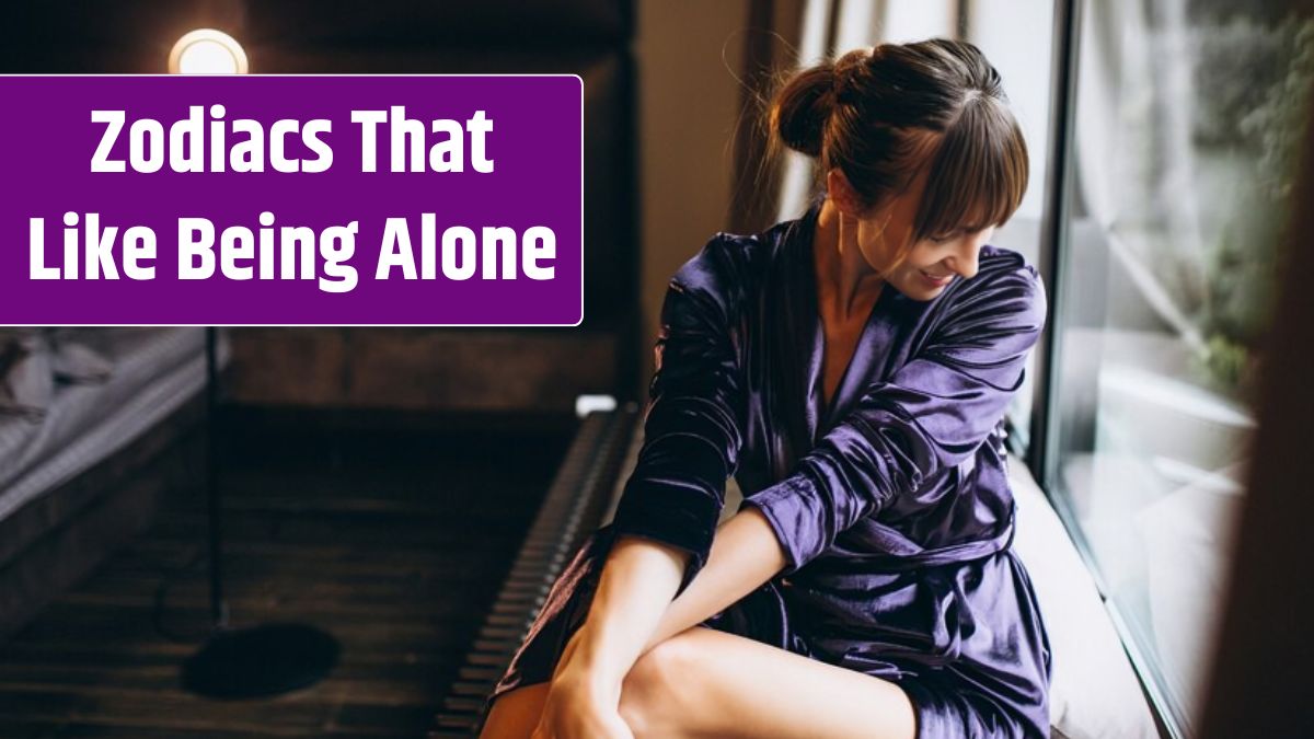 Woman in purple bathrobe in bedroom.