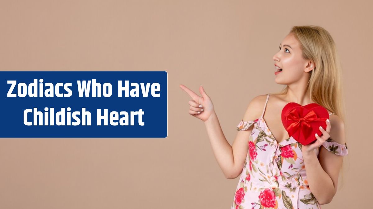 Front view of young female posing with red heart shaped present on brown wall.