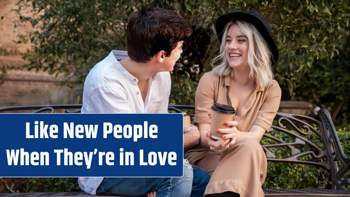 Couple smiling and talking on bench at the park.